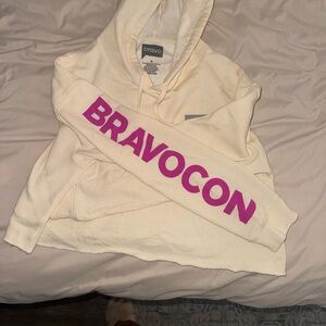 Cream Hoodie with Pink Bravocon Logo